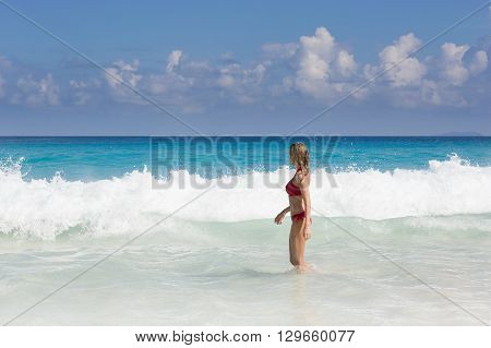 Beautiful and sexy blonde woman in red bikini, turquise sea