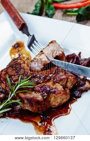 Beautiful Juicy Pork Steak Cooked On The Grill With Caramelized Onions