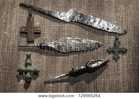 early medieval copper Christian crosses, iron tips of arrows and the forged knife