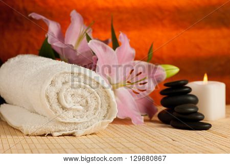 towel flowers and massage rocks set up on a table in wellnes center