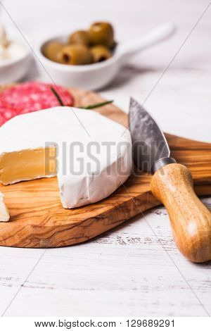 Camember chese apetizer with nuts and meat snacks