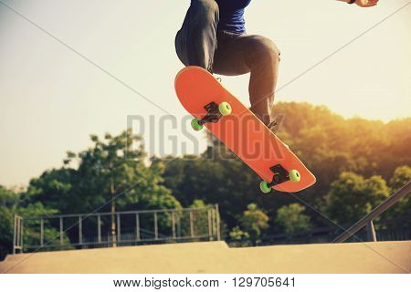 young skateboarder skateboarding at outdoor skate park