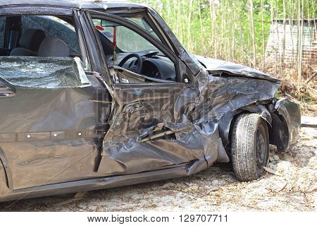 A wrecked car lays in wait after a vicious car accident. 