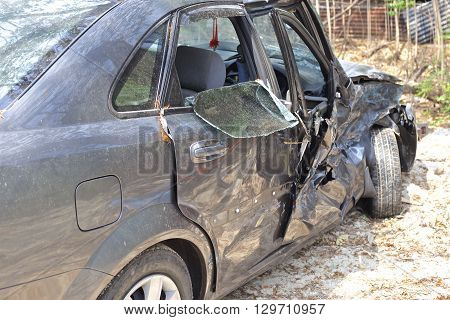 A wrecked car lays in wait after a vicious car accident. 