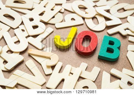 Colorful Job wording - text uppercase letter made from wood mix with other wooden alphabet - concept of job hunting