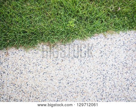 Close up half of stone walkway and grass - small gravel floor and grass for background and texture