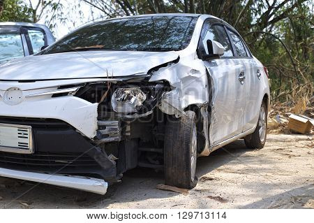 A wrecked car lays in wait after a vicious car accident. 