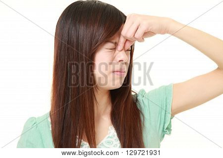 portrait of young woman suffers from Asthenopia on white background