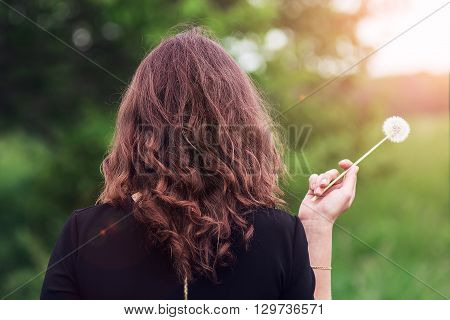 Girl With A Dandelion In The Hand
