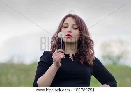 Girl With A Dandelion In The Hand