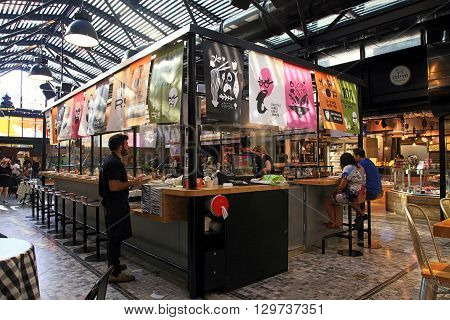 TEL AVIV, ISRAEL - APRIL 7, 2016 : People having lunch in a modern open kitchen restaurant in Sarona Market, Tel Aviv, Israel. Recently open Sarona Market became the most popular place in Tel Aviv.