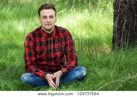 Guy Sitting On The Grass