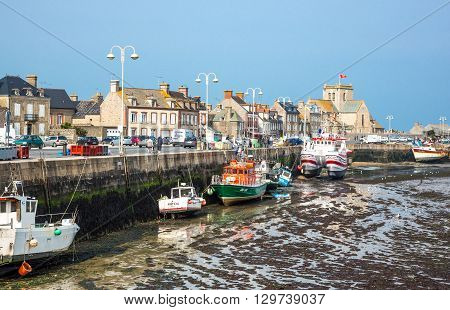 Barfleur France - May 21 2012: Normandy view of the harbor and boats at low tide near the village.