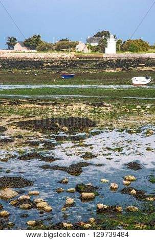 Barfleur France - May 21 2012: Normandy view of the harbor and boats at low tide near the village.