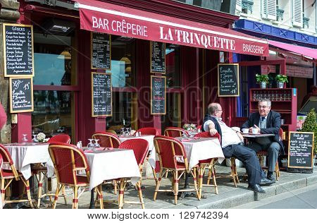 Honfleur France - May 19 2012: Normandy local people in a bar creperie in the old harbor basin