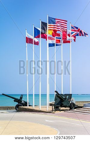 France Normandy Arromanches flags and weapon in the places of the second World War landing memorial.