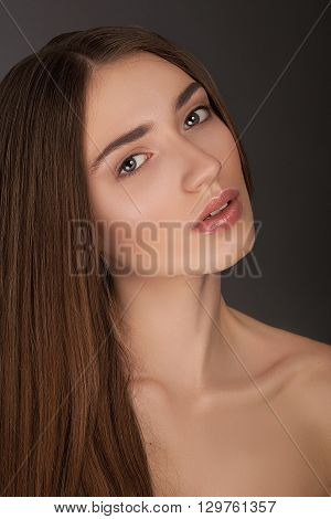 beautiful model lady with natural make-up. studio fashion shot on dark background perfect skin