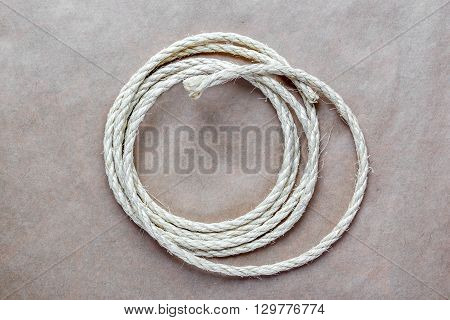 rope coiled at kraft paper on the background close up