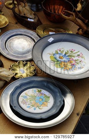 Pewter plates decoration objects flea market still life.
