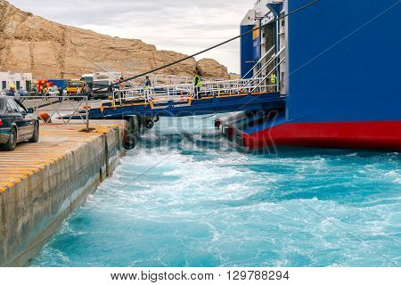Santorini, Greece - May 2, 2016: The big sea ferry is moored off in the port of Athinios on the island of Santorini. Sea ferries make regular flights between the Greek islands.