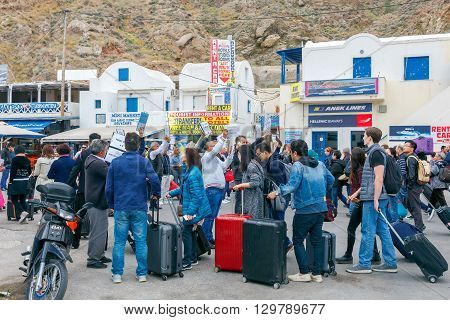 Santorini, Greece - May 2, 2016: Meeting tourists at the dock in the sea port of Santorini Athinios. Santorini is part of the five most visited tourist destinations in the world.