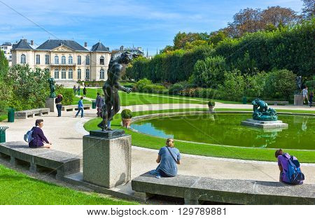 Paris France - August 31 2011: Visitors and sculptures of August Rodin in the Rodin Museum garden.