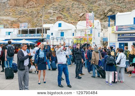 Santorini, Greece - May 2, 2016: Meeting tourists at the dock in the sea port of Santorini Athinios. Santorini is part of the five most visited tourist destinations in the world.