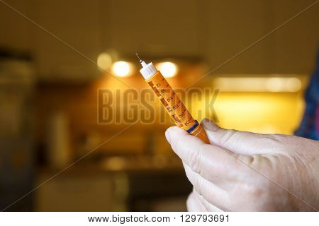 Hyperglycemic diabetic patient with prepared insulin shot at home in the kitchen before eating. Medical process self-diagnose common metabolic widespread and modern epidemic disease concept.