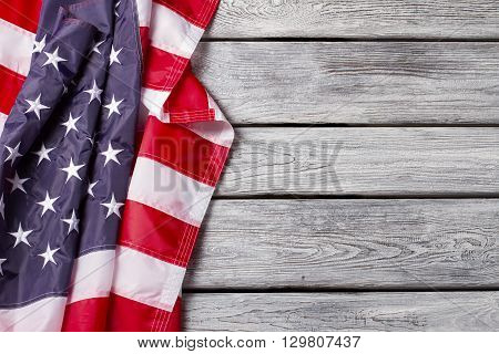 Creased flag of US. National flag on wooden background. Democracy drives the progress. Have faith in brighter future.
