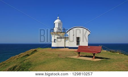 Small old lighthouse on a hill in Port Macquarie. Bench. Scene in Australia.