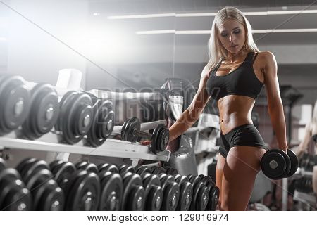 athletic young woman resting during exercise in the gym
