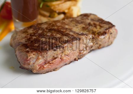 Juicy beef steak with sauce and garnich