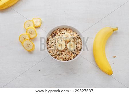 Healthy breakfast with muesli and banana top view