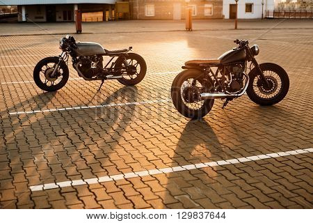 Two Black And Silver Vintage Custom Motorcycles Caferacers