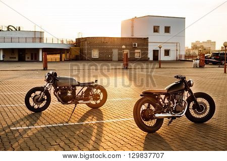 Two Black And Silver Vintage Custom Motorcycles Caferacers