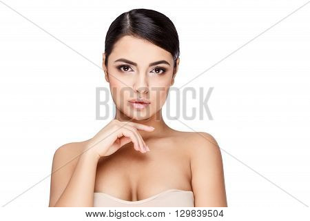 Brunette young woman with beautiful clean skin isoilated on white