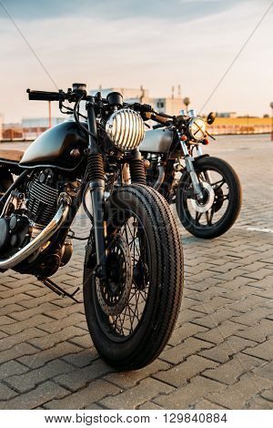 Two Black And Silver Vintage Custom Motorcycles Caferacers