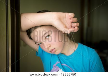 A sad little girl is standing on his doorstep