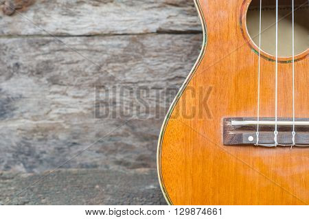 abstract portrait of a ukulele on old wood background