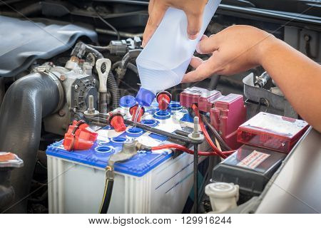 car battery maintenace with distilled water, garage
