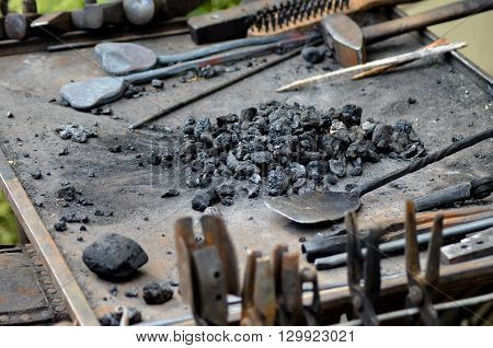 Blacksmith working on metal medieval fire iron hammer work