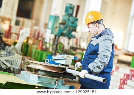 industrial factory worker with tube bending machine