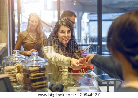 Young Brunette Woman Making Payment At A Till