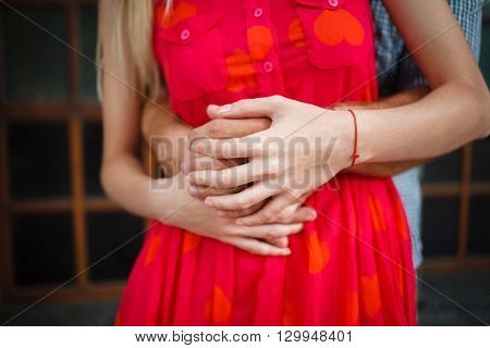 Detail of holding hands of a loving couple