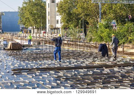 Workers Carry Iron Rods For Constructing The Base Plate