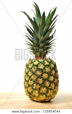 Pineapple on wooden table with white background isolated