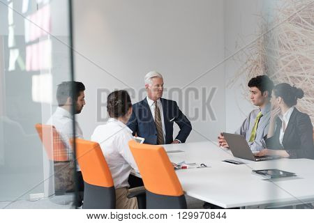 business people group brainstorming on meeting and businessman presenting ideas and projects oon laptop and tablet computer
