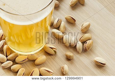 The beer with pistachios. The top view. The bar. The background.