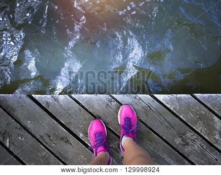 Fitness motivation summer sport picture. Pinl sneakers near water