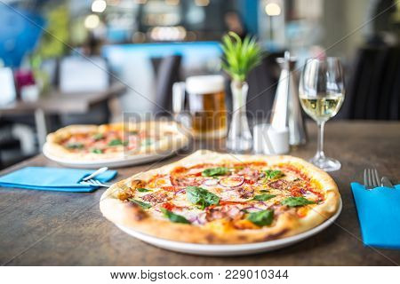 The Served Dinner Table With Pizza In Pizzeria Or  Restaurant.